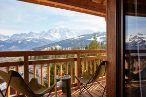 a balcony with chairs and a view of mountains at Chalet Alpen Valley, Mont-Blanc in Combloux