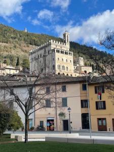 a large building with a castle on top of it at A Casa di Ale in Gubbio