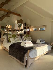 a bedroom with two beds with towels on them at Glastonbury tranquility in Glastonbury