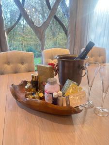 a tray of food on a wooden table with wine glasses at Glastonbury tranquility in Glastonbury +28 photos