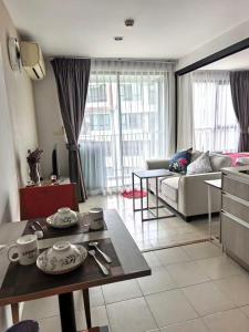 a living room with a couch and a table at Centrio phuket 07 in Ban Rangeng