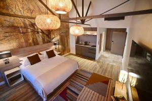 a bedroom with a large bed and two lights at Walnut Bistro & Suites in Eymet +15 photos