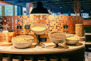 three bowls of food sitting on a table at Hotel Laudinella in St. Moritz