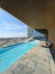 a swimming pool on top of a building at 21st Floor Sunset Apartment - Mercury Tower with Pool Access by Stays Uniq in St. Julianʼs +55 photos