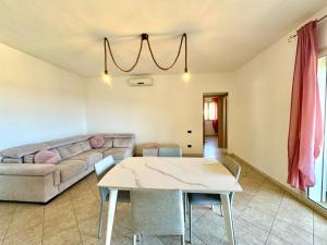a living room with a couch and a table at Skyline Terrace in Loceri +18 photos