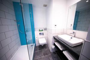 a bathroom with a sink and a toilet and a shower at Holiday Inn Kenilworth - Warwick by IHG in Kenilworth +52 photos