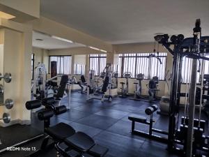 a gym with treadmills and machines in a room at Relax Crib Nairobi in Nairobi