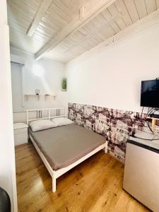 a bedroom with a bed and a tv in it at Anna Vendégház Szilvásvárad in Szilvásvárad