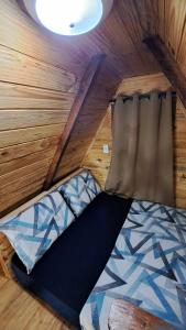 a bedroom with a bed in a tiny house at Chalé da Ilha in Guaraqueçaba