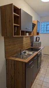 a kitchen with a sink and a counter top at Pension Sonne in Baden-Baden