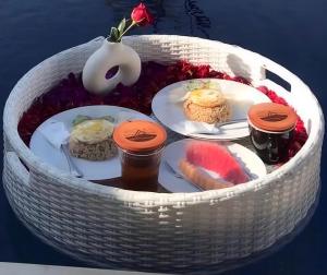 a white basket with plates of food in it at Highland Bali in Baturaja +33 photos