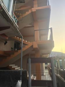 a building with a spiral staircase on the side of it at Jinkos Homestay with self cooking facility in Itānagar