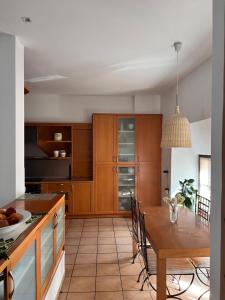 a kitchen with wooden cabinets and a wooden table at Αρχοντικό Λίθος in Kastoria