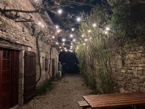 an alley with lights and a bench in a tunnel at La maisonnette de la venelle in Chaunay