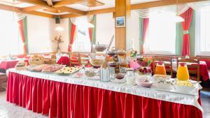 a table with food on it in a room at Pension Helios in Sankt Kanzian