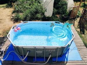 a large hot tub sitting on a wooden deck at Le Nautile - petit déjeuner - 10mn du Parc in Treize-Vents
