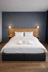 a bedroom with a large white bed with towels on it at ATAKORU Suit in Alacaatlı