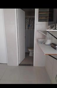 an open door to a bathroom with a toilet at Casa na várzea Quarto 1 in Recife