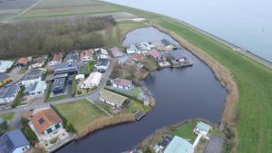 an aerial view of a group of houses next to a river at Seehund 102 in Sint Annaland