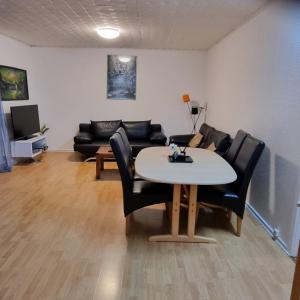 a living room with a table and chairs and a couch at Joysha's House in Ikast