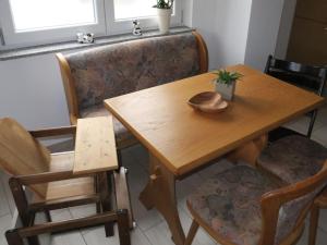 a dining room table with two chairs and a wooden table at Ferienhof Windegg in Stockach