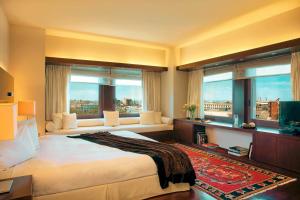 a bedroom with a large bed and two windows at Zeus Thessaloniki Lazart in Thessaloniki