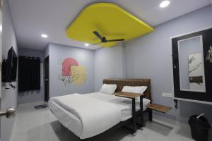 a bedroom with a bed with a green ceiling at Tharvi Hotels in Jāmb