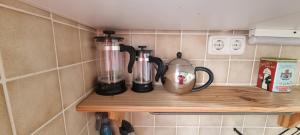 a kitchen shelf with two coffee makers and a blender at Apartment 11 A in BRE