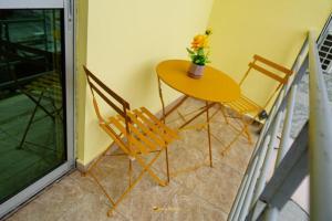 a table and two chairs sitting next to a door at Cozy loft Bonamoussadi Douala in Douala