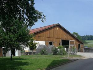 a large wooden barn with a gambrel at Ferienhof Windegg in Stockach