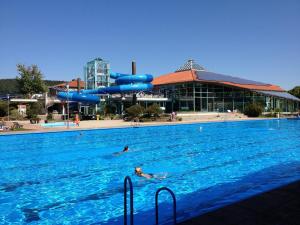 a person swimming in a swimming pool with a water park at Ferienwohnung Schabmüller in Kelheim