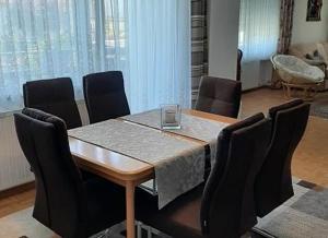 a dining room with a table and chairs at Ferienwohnung Schabmüller in Kelheim +13 photos