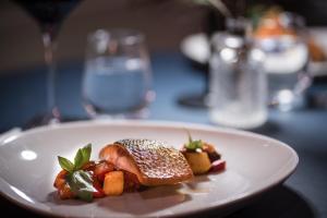 a white plate with food on a table at Flower Pot Hotel in Henley on Thames