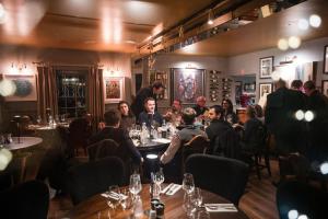 a group of people sitting at tables in a restaurant at Flower Pot Hotel in Henley on Thames