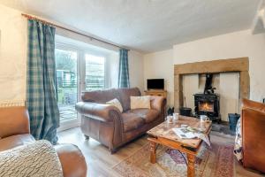 a living room with a leather couch and a fireplace at 3 Bed in Nenthead oc-c34668 in Nenthead