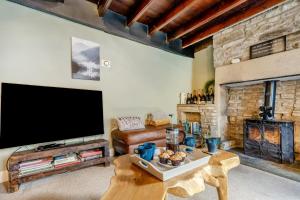 a living room with a large television and a fireplace at 4 Bed in Nenthead oc-c34669 in Nenthead