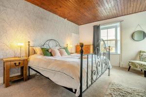 a bedroom with a bed and a chair and a window at 4 Bed in Nenthead oc-c34669 in Nenthead