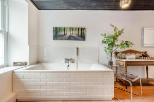 a white bath tub in a room with a table at 4 Bed in Nenthead oc-c34669 in Nenthead +13 photos