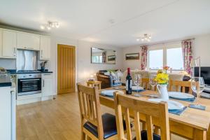 a kitchen and living room with a table and chairs at 2 Bed in Coaley oc-s34729 in Coaley +12 photos