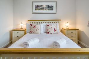 a bedroom with a white bed with two night stands at 2 Bed in Coaley oc-s34729 in Coaley