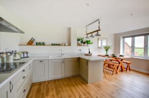 a kitchen with white cabinets and a wooden floor at 2 Bed in Newton oc-ffba in Newton