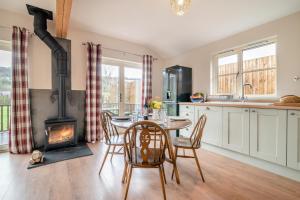 a kitchen with a table and a wood stove at 2 Bed in Coaley oc-r34730 in Coaley