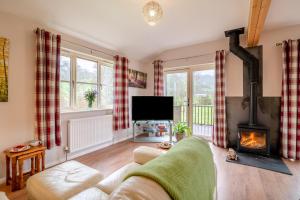 a living room with a couch and a fireplace at 2 Bed in Coaley oc-r34730 in Coaley