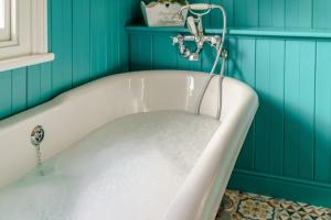 a bath tub in a room with blue walls at 3 Bed in Gosforth oc-s34885 in Gosforth +14 photos