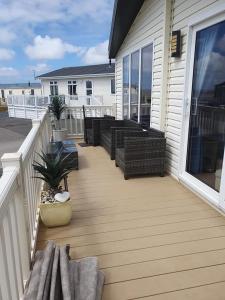 a wooden deck with benches on a house at Jasper Lodge in Morecambe
