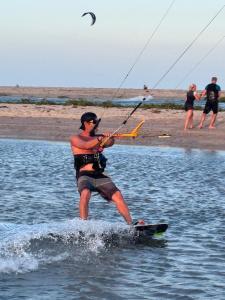 a man on a surfboard in the water at Vila Macapaz Kitesurf in Luis Correia