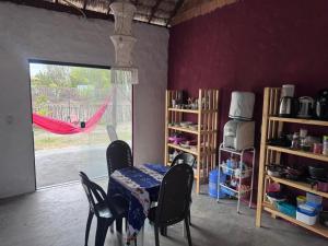 a dining room with a table and chairs and a window at Vila Macapaz Kitesurf in Luis Correia