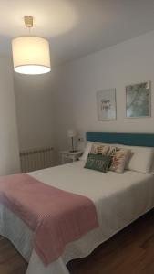 a bedroom with a large white bed with a lamp at Bruma in Vilagarcia de Arousa +45 photos