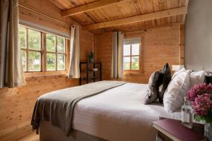 a bedroom with a large bed in a wooden room at 6 Bed in Alkham oc-p34791 in Swingfield