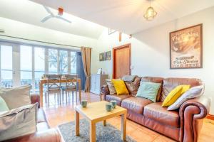 a living room with a leather couch and a table at 2 Bed in Escomb oc-o34978 in Acomb